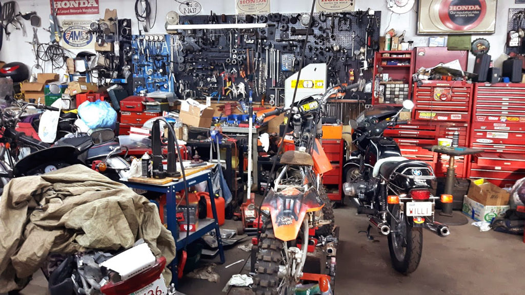 Motorcycle garage with various parts and tools