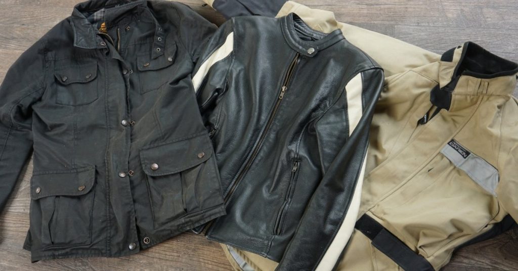 Common motorcycle gear materials, including waxed cotton, leather, and waterproof synthetic.