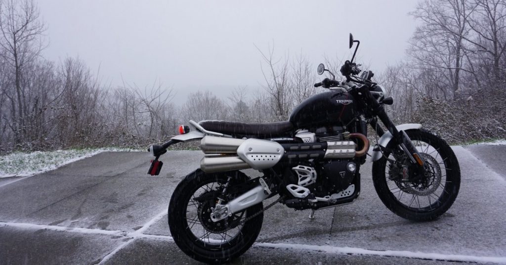 Motorcycle parked on a road in the middle of a snowstorm in North Carolina.